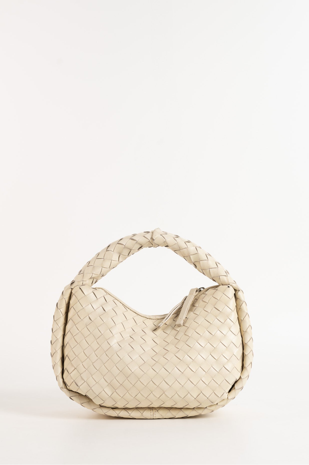 Beige woven handbag on a white background
