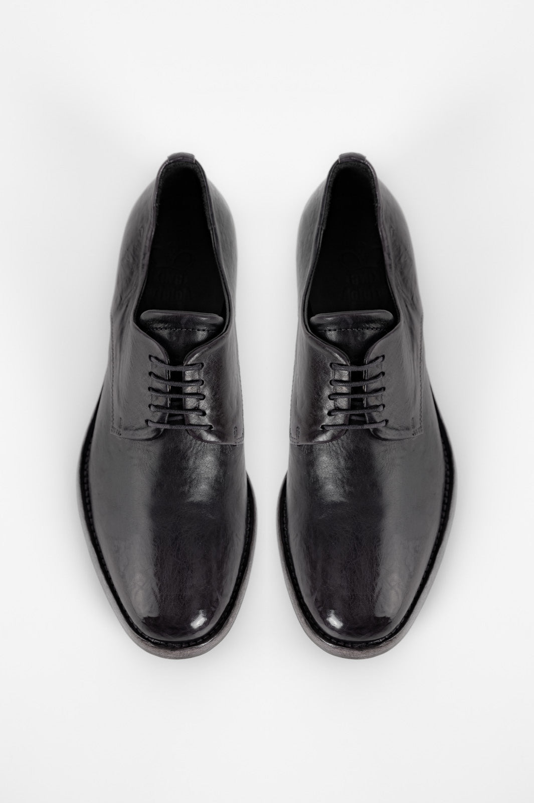 Pair of black dress shoes on a white background