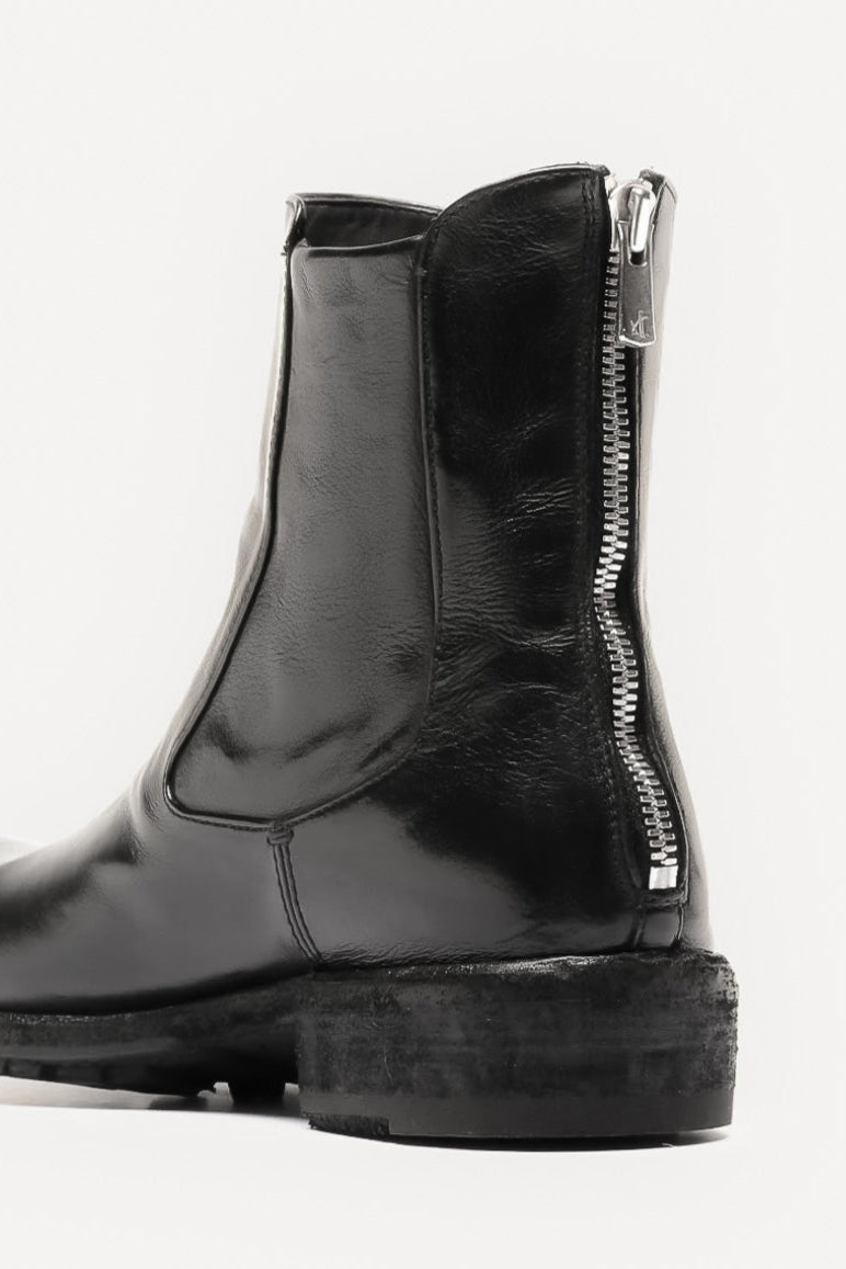 Black rubber boot with a zipper on a white background