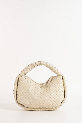 Beige woven handbag on a white background