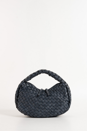 Black woven handbag on a white background