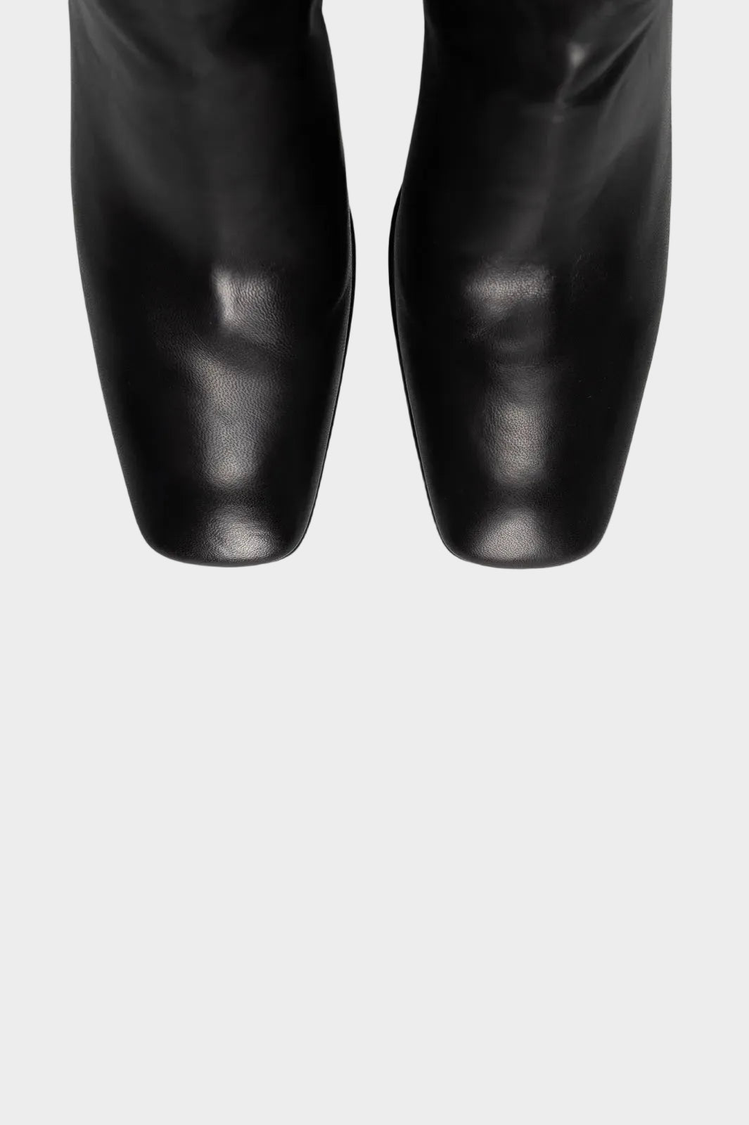 Black leather boots with square toes, shown from a top-down view against a plain white background.