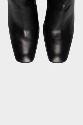 Black leather boots with square toes, shown from a top-down view against a plain white background.