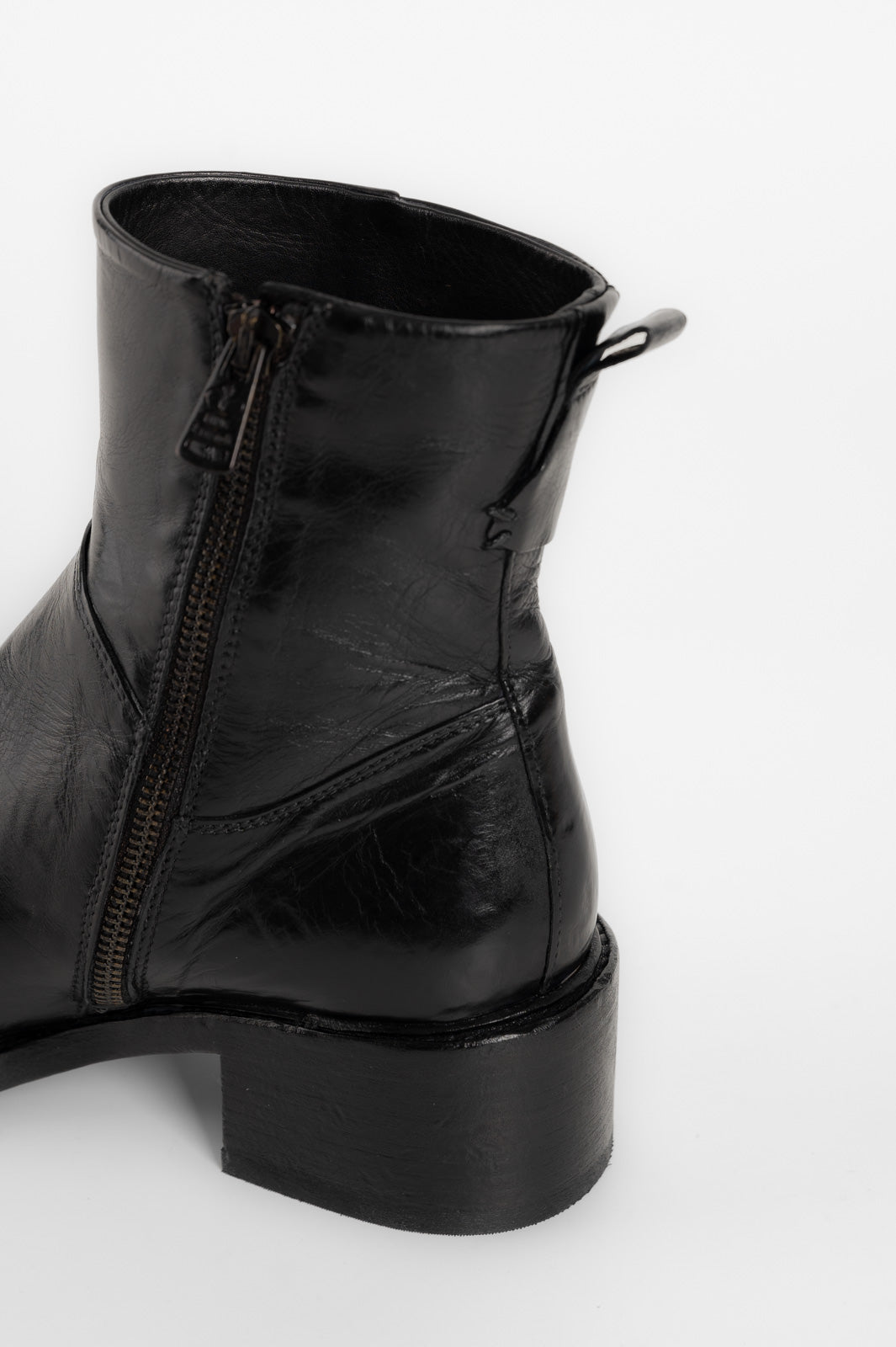 Black leather boot with a platform sole on a white background
