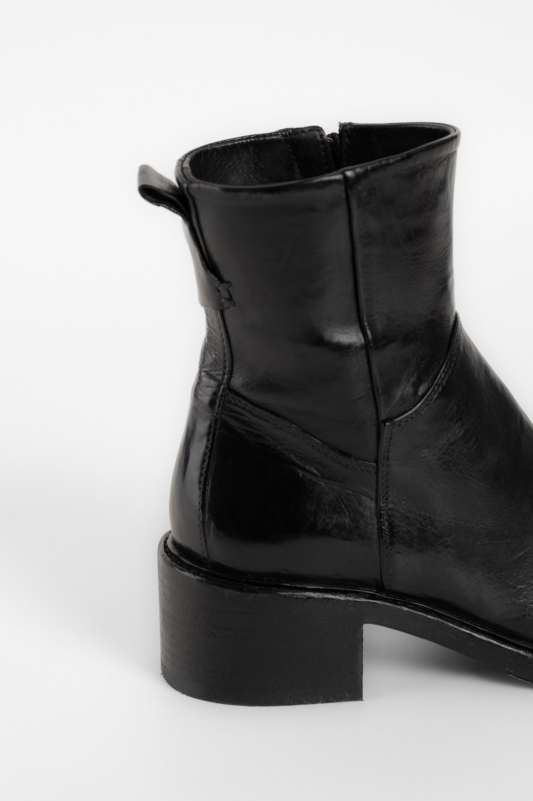 Black leather ankle boot on a white background