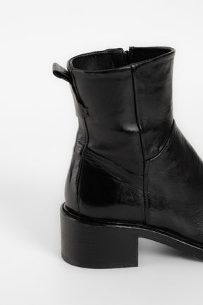 Black leather ankle boot on a white background