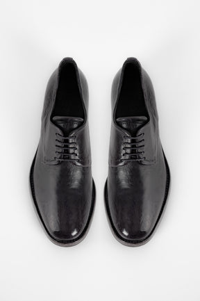 Pair of black dress shoes on a white background