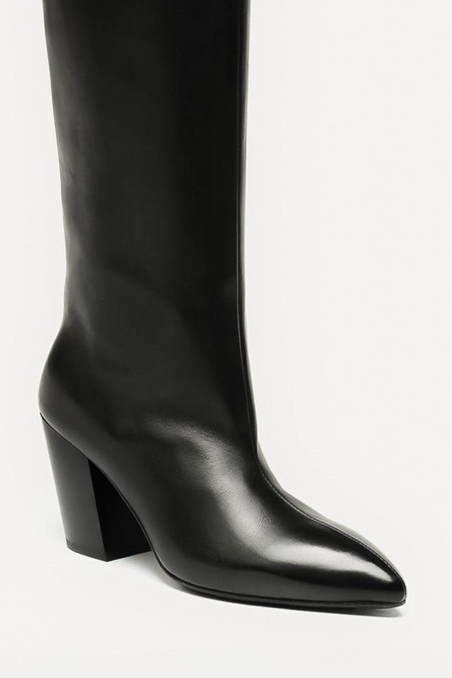 Black knee-high boot on a light gray background