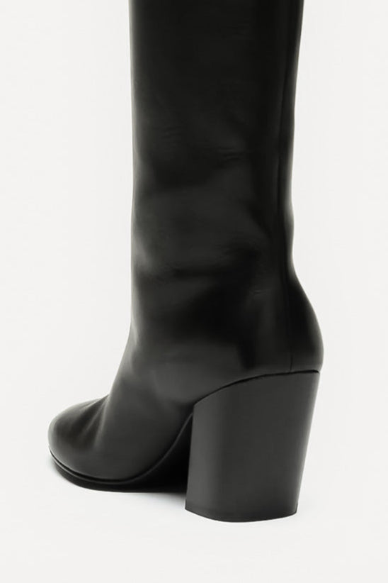 Black knee-high boot on a white background